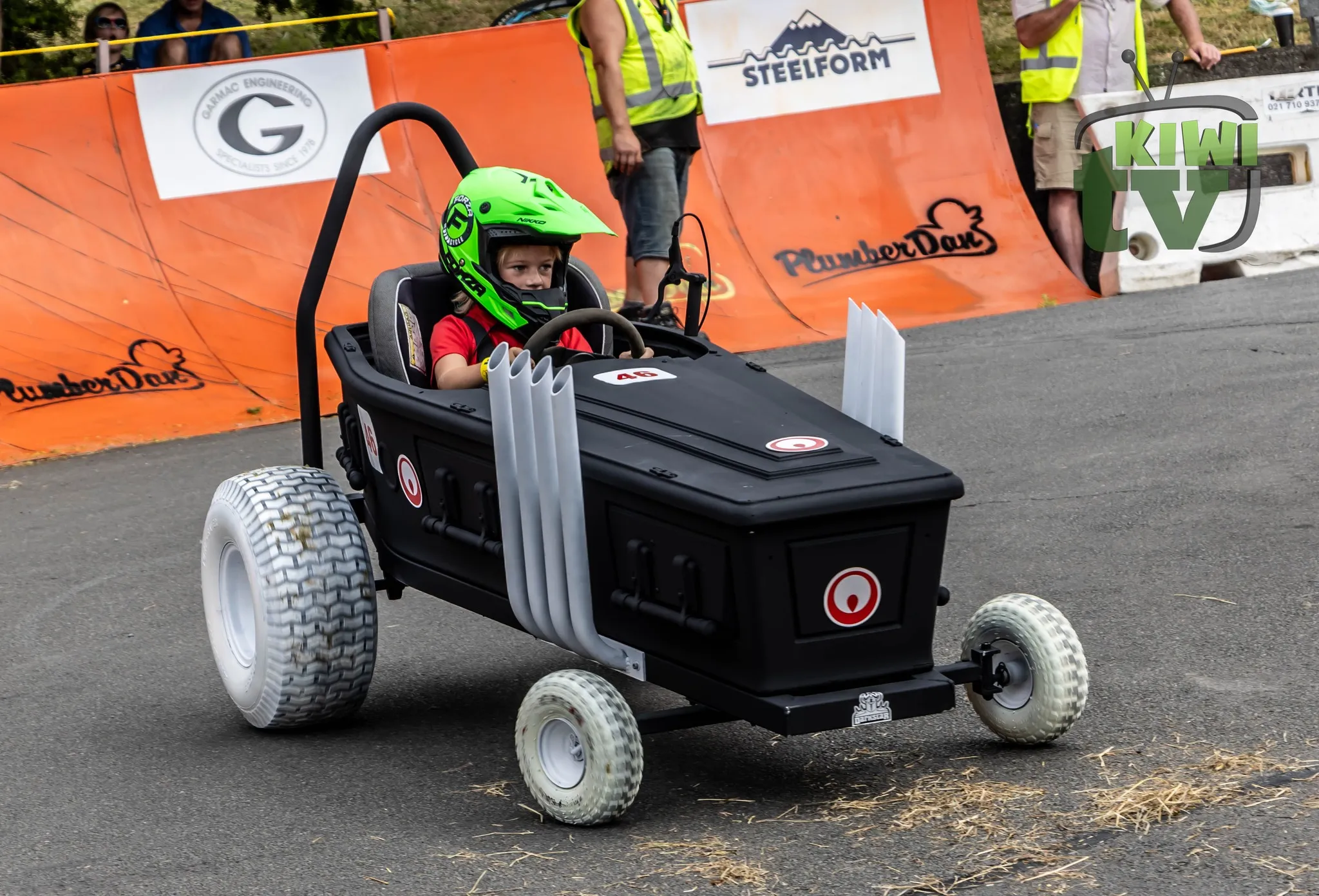 Racer launching down Drews Ave during the 2024 PlumberDan Soap Box Derby