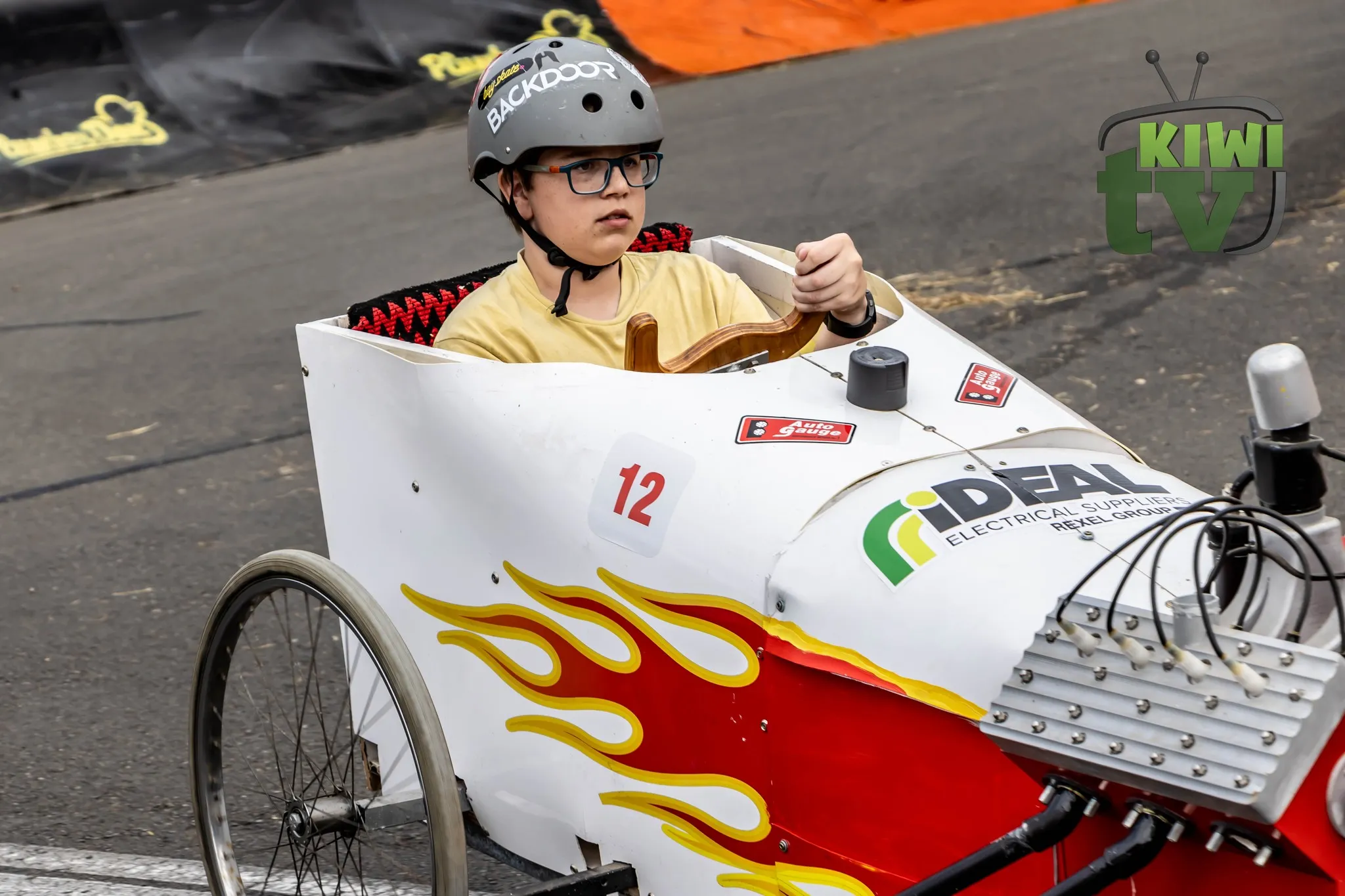 Soap box racer tilting around hay bales in 2023