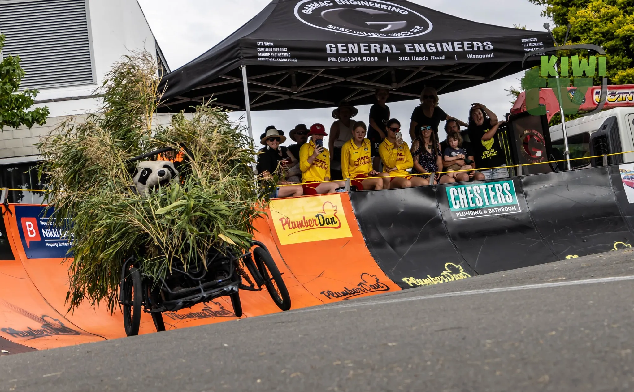 Spectators lining the footpath with cheering signs