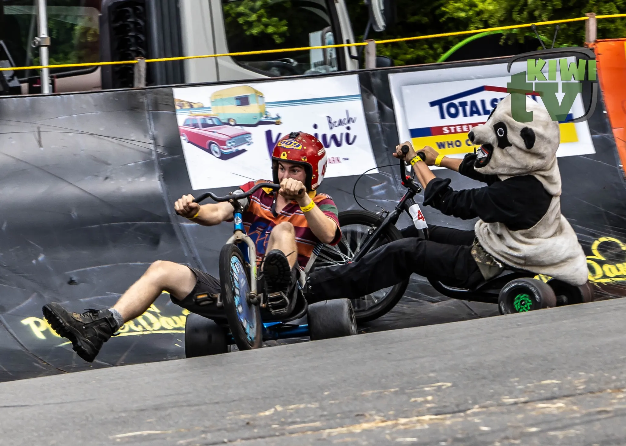 Historic soap box racer display surrounded by visitors in 2019